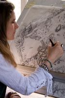 Woman working on garden design at drawing board