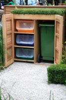 Wooden dustbin and recycling cupboard in The Children's Society Garden, Designed by Mark Gregory, Sponsor - The Co-operative,
Chelsea Flower Show 2008
