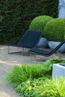 Garden chairs, topiary Buxus balls in zinc containers and green planting - The Laurent Perrier Garden - Winner of Gold Medal and Best Show Garden RHS Chelsea 2008