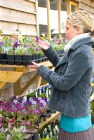 Lady buying plants in garden centre