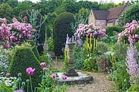 The sundial surrounded by summer flowers in June - Chenies Manor Gardens