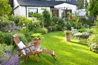 Reclining chair on lawn in urban garden