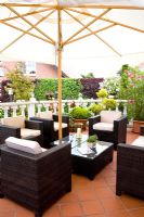 Sitting area under umbrella on terrace