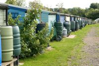 Rear of allotment holders' huts showing emphasis on rain water collection