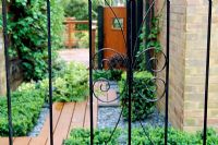 Metal gate with view through to garden