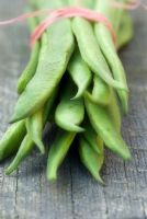 Runner beans on wooden surface