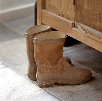 Muddy boots on tiled floor