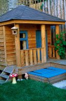 Decked walkway connecting decking area to playhouse