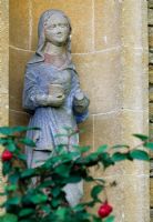 Statue of the virgin in a niche on the facade of the cloisters at Iford Manor
