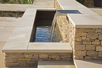 Raised limestone contemporary water feature on a large terrace