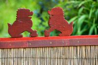 Two small carved lions on a gate into the kitchen garden - Beggars Knoll, Newtown, Westbury, Wiltshire, UK