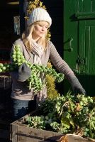 Woman buying Brussels sprouts at farm shop