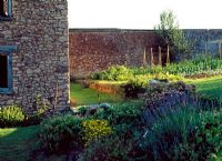 Mixed walled vegetable garden and flowerborder