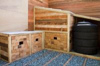 A seat with storage areas and a compost bin created from car tyres with gravel and timber path in the Marshalls Living Street Garden, sponsored by Marshalls plc - Silver-Gilt Flora medal winner at RHS Chelsea Flower Show 2009
