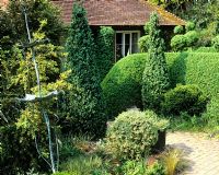 Metal sculpture in topiary garden - Charlotte Molesworth's garden, Kent