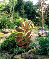 Rustic leaf sculpture by Peter M Clark, gravel garden - Charlotte Molesworth's garden, Kent