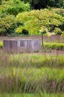 Seating in the Drifts of Grasses Garden at Scampston Hall, Yorkshire