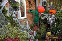 Halloween decorations of scary Pumpkin headed scarecrows 