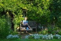 Joy Martin relaxing in her garden - Wild Rose Cottage, Lode, Cambridge