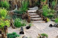 Seaside garden planted with a range of grasses, driftwood steps, Design - Kei Iwata, Hampton Court Flower Show