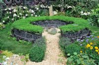 Chamomile covered circular seat, Design - Yvonne Mathews, Hampton Court Flower Show 