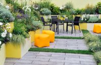 Patio garden with extensive planting in brightly painted raised beds - RHS Tatton Park Flower show