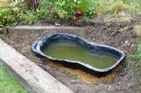 Garden pond project - step by step - moulded lining filled with water