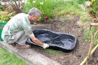 Garden pond project - step by step - whole in ground being prepared for the mould