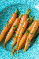 Cooked carrots in a blue bowl
