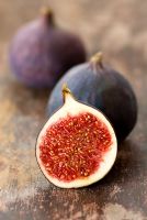 Sliced fresh fig on wooden table