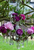 Old rose varieties displayed on vintage chandelier 