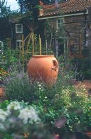 Cermaic urn surrounded by lavender and perennials