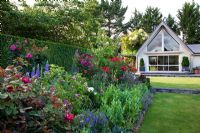 Herbaceous flowerbeds and view of house - Breedenbroek, New Zealand