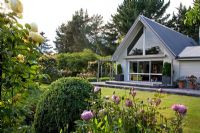 Herbaceous flowerbeds and view of house - Breedenbroek, New Zealand
