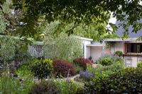 View of house and herbaceous flowerbeds - Breedenbroek, New Zealand