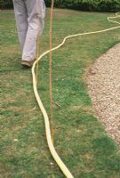 How to mark out your plot.  A brightly-coloured hosepipe is ideal for using as a guide to mark the boundary of a bed or border - or to mark the edges and route of a new path.