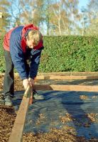 Making a pergola - Level the ground using planks before starting the uprights, it's a lot easier to manipulate this at ground level than it is in the air