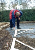Making a pergola - Once the centre of each hole has been located, position the meta spikes. Care should be taken when positioning these, as the posts can twist in the soil