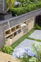Sunken patio area with storage built into wall of raised bed. 'A Joy Forever' Garden, Silver medal winner at RHS Chelsea Flower Show 2010 
 