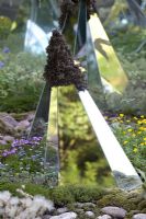Glass mirrors on diamond shaped structures amongst moss covered rocks. Alpine flowers. Lights and Colours of the Alps garden, Bronze medal winner, RHS Chelsea Flower Show 2010
 