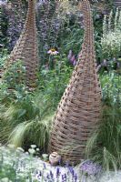 Willow sculptures in borders. 'It's Only Natural' - Silver Gilt Medal Winner - RHS Hampton Court Flower Show 2010 