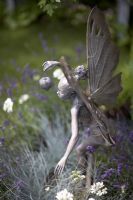 Fairy sculpture holding cape gooseberry in Lavender. 'A Midsummer Night's Dream' - Silver Medal winner - RHS Hampton Court Flower Show 2010 