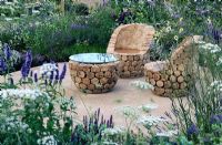 Teak log chairs and table - 'The Copella Bee Garden', Silver Gilt medal winner at RHS Hampton Court Flower Show 2010
 

