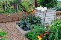 Timber framed vegetable boxes and bee hive in kitchen garden. RHS Tatton Park Flower Show 2010
