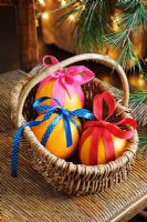 Oranges decorated with brightly coloured ribbons for Christmas