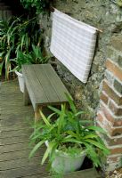 Wooden bench made from wooden decking. Late Spring,  Fovant Hut Garden, Wilts.