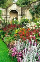 Herbaceous border of Cosmos 'Gazebo Mixed', Crocosmia 'Lucifer', Stachys byzytina, Rudbeckia, Gladioli, Heuchera, Persicaria - Dewstow Garden and Grottoes, Monmouthshire, Wales