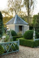 Gravel path leading to attractive garden shed. Silverstone Farm, Norfolk
