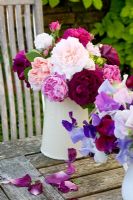 Jug of mixed roses on table - David Austin and old varieties