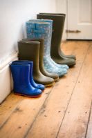 Four pairs of wellies of a gardening family in hallway